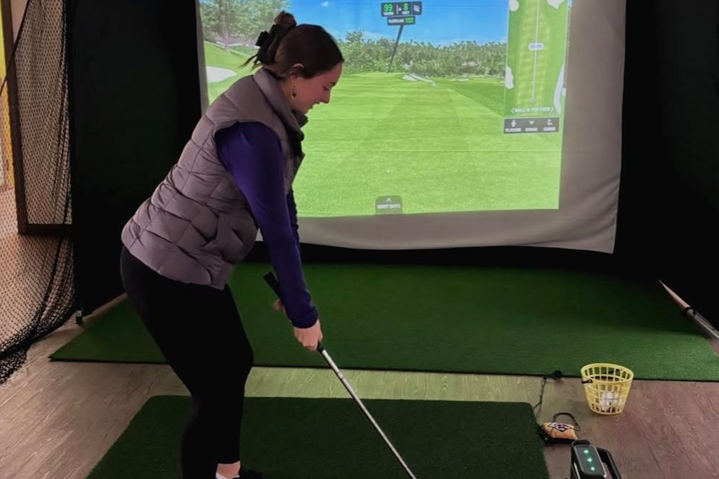 Golfer at golf simulator